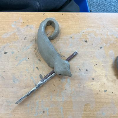 Children making clay lizards